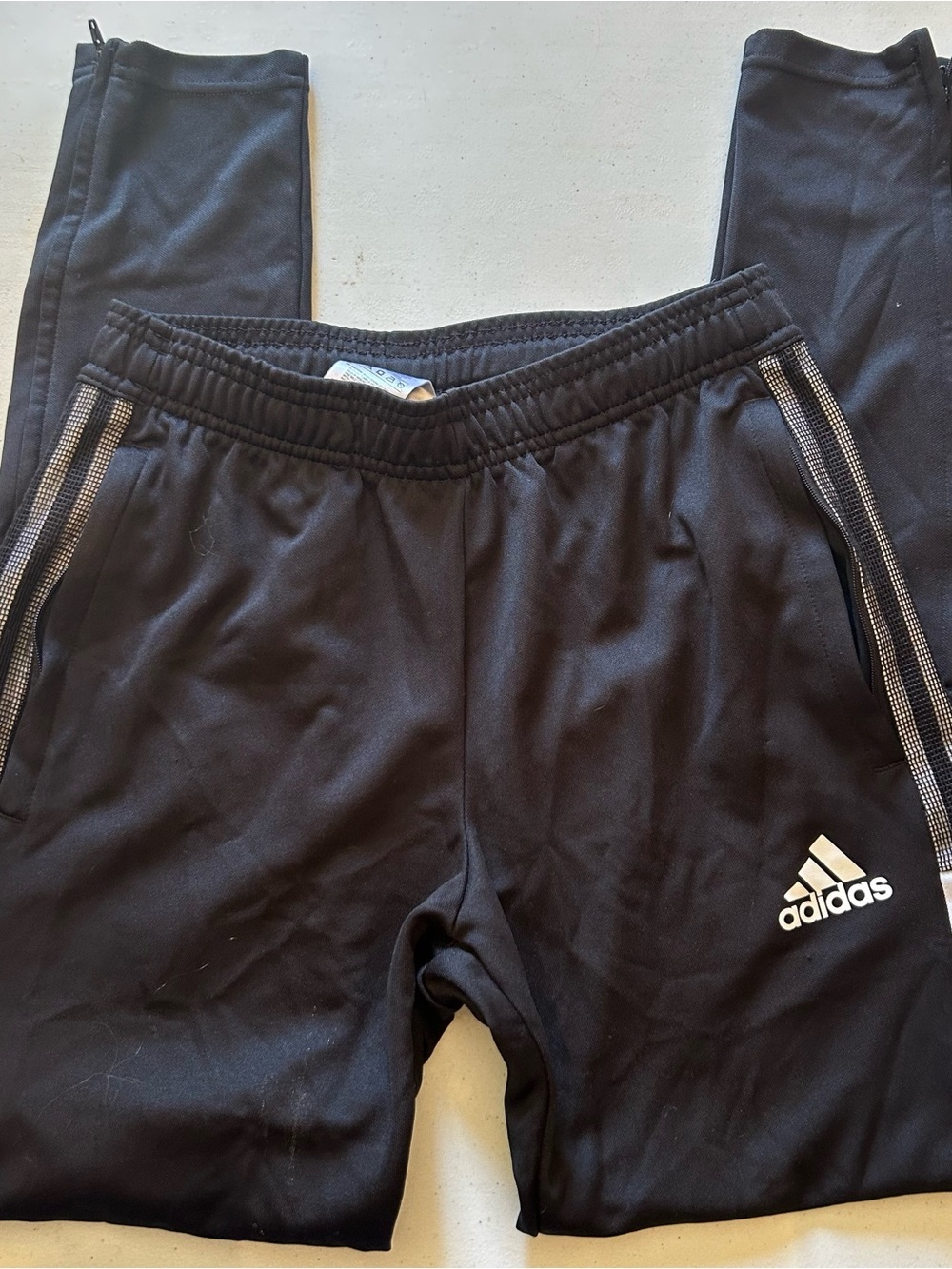 Adidas black track pants with white stripes, zippers size S